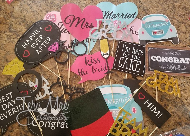 Assorted wedding photo booth props: hearts, speech bubbles, car cutouts, and signs