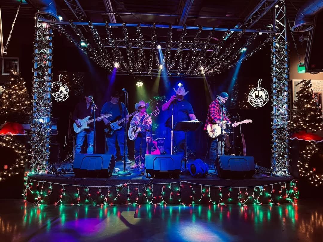 Northbound band performing on a decorated stage with colorful lights and holiday garlands