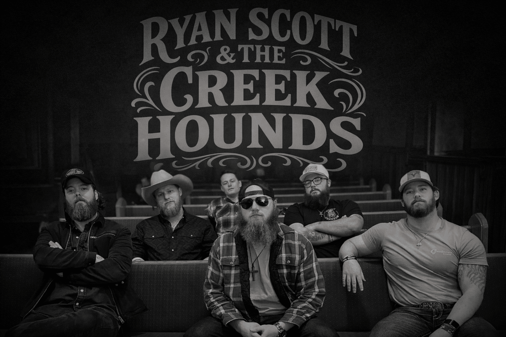 Black-and-white band photo of Ryan Scott and the Creek Hounds with five men posing in front of a logo.