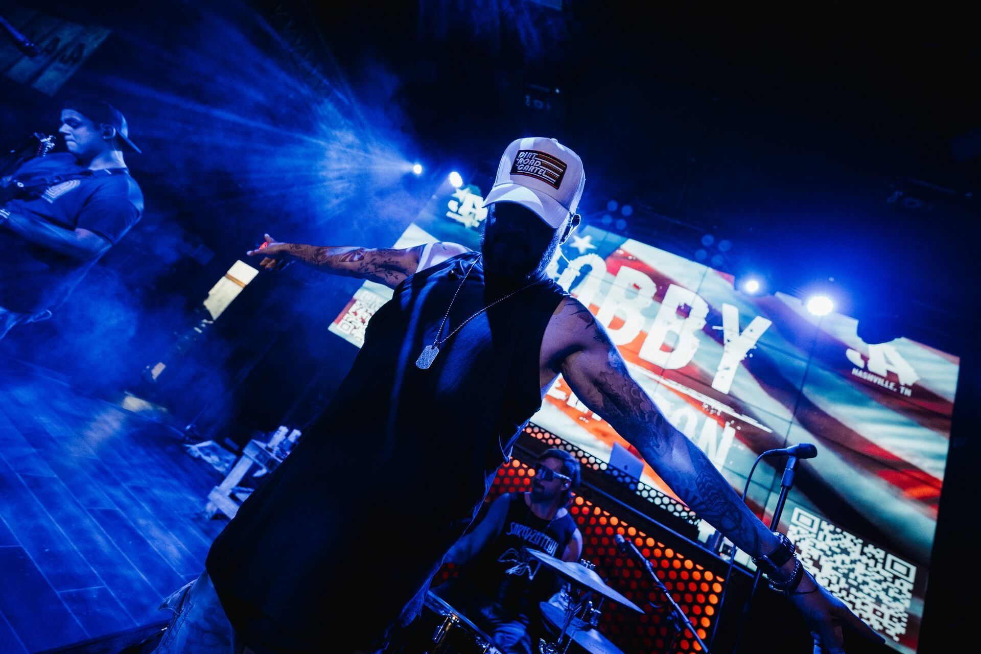 A man is standing on a stage in front of a large screen that says hobby.