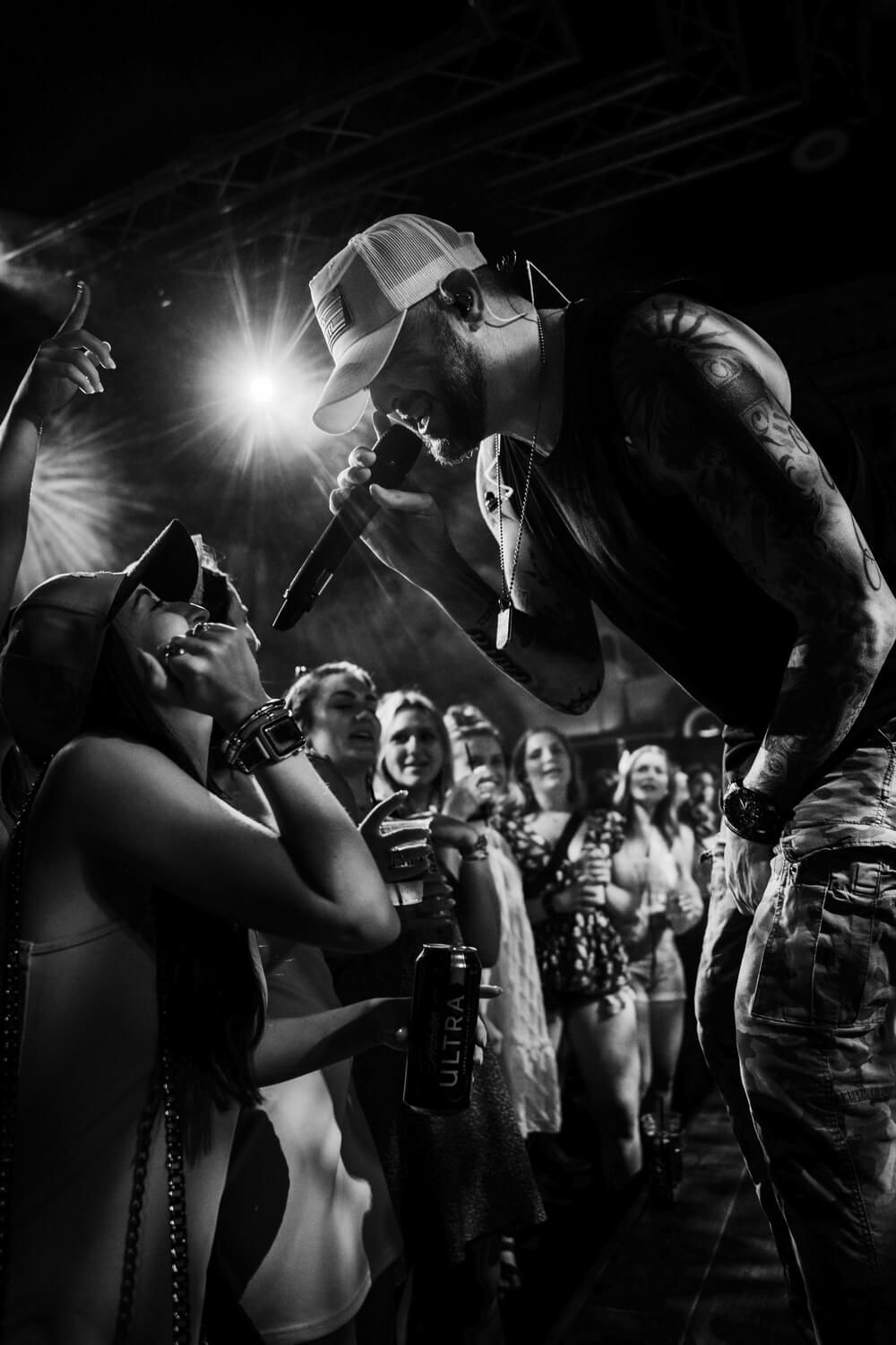 An acoustic guitar is sitting on a wooden chair.