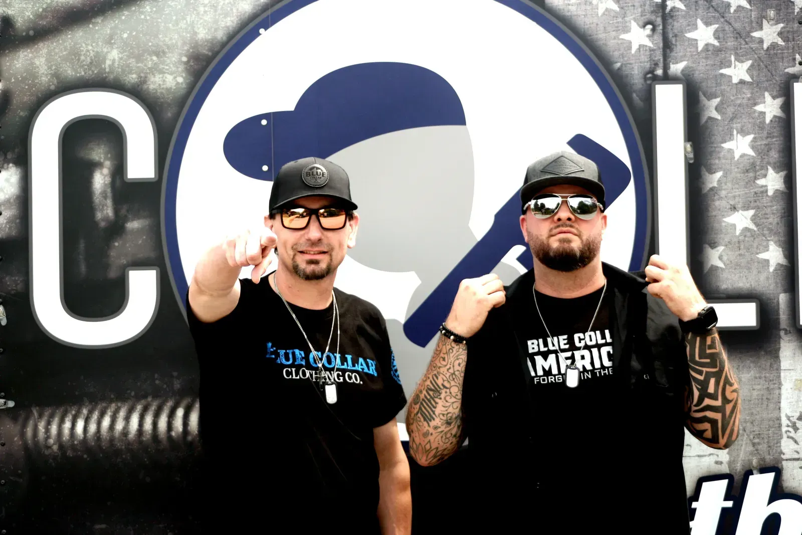 Two men standing in front of a sign that says cool.