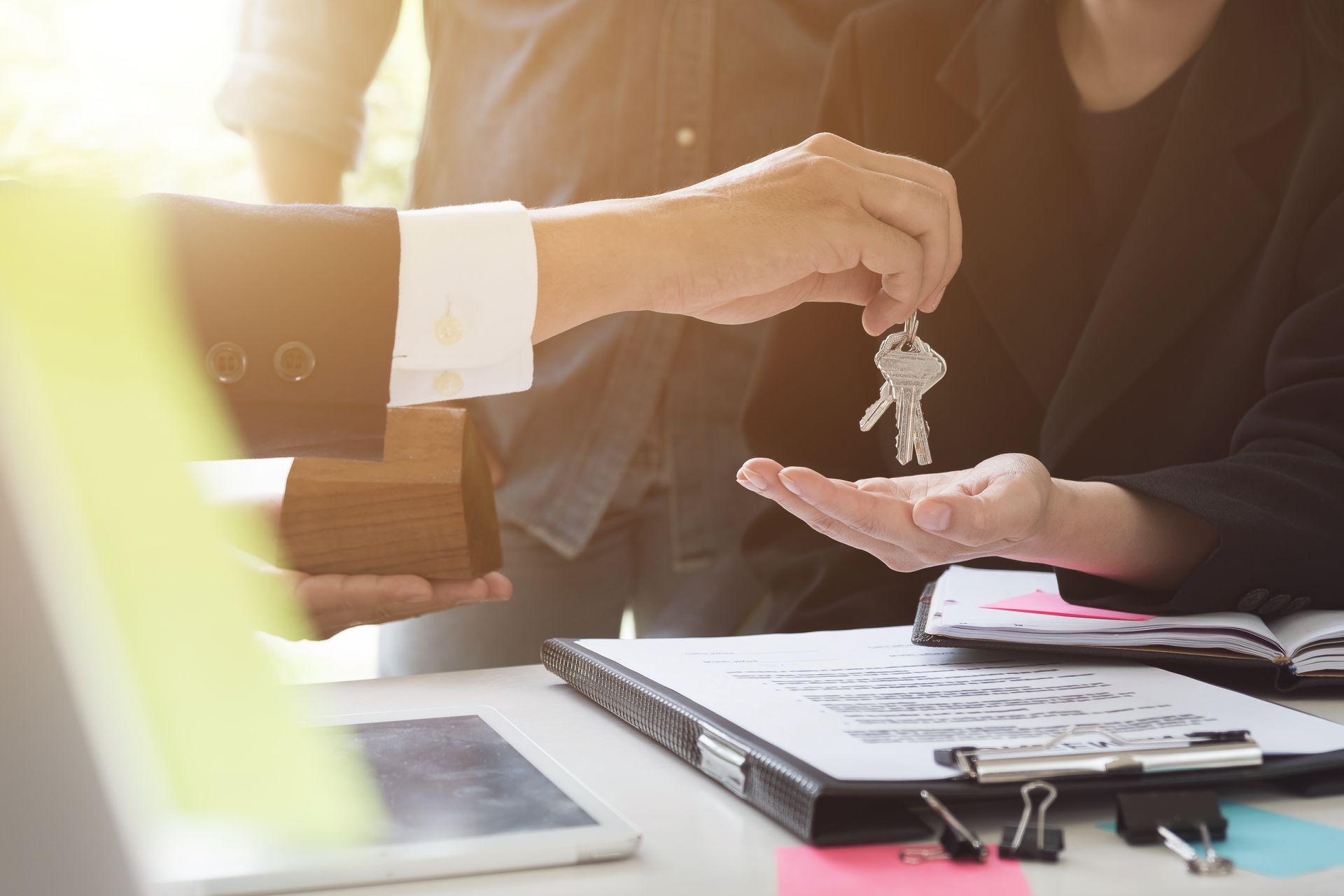 Real estate attorney handing keys to client