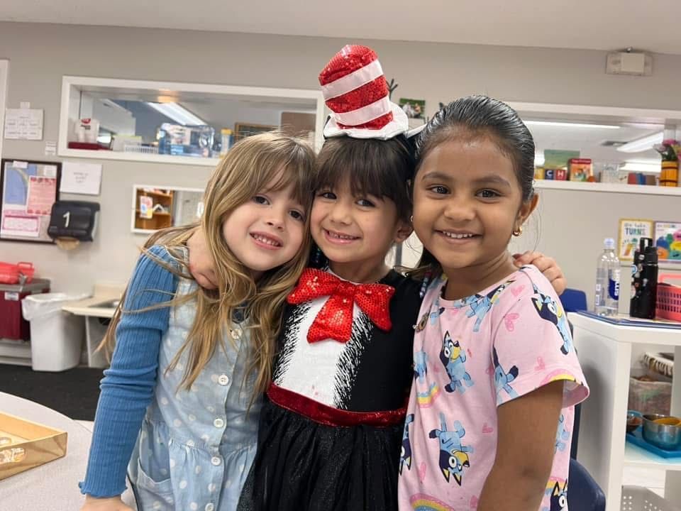 Two Little Girls Are Sitting on the Floor Playing With Toys