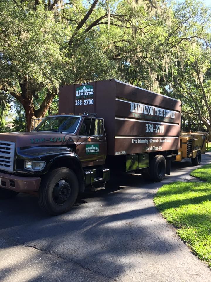 A large brown truck is parked on the side of the road.