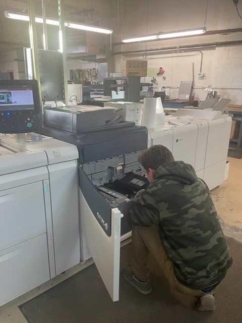 Man Checking Printer — Viroqua, WI — Proline Printing