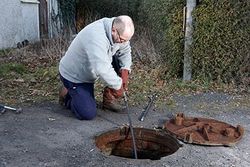 man cleaning out septic tank