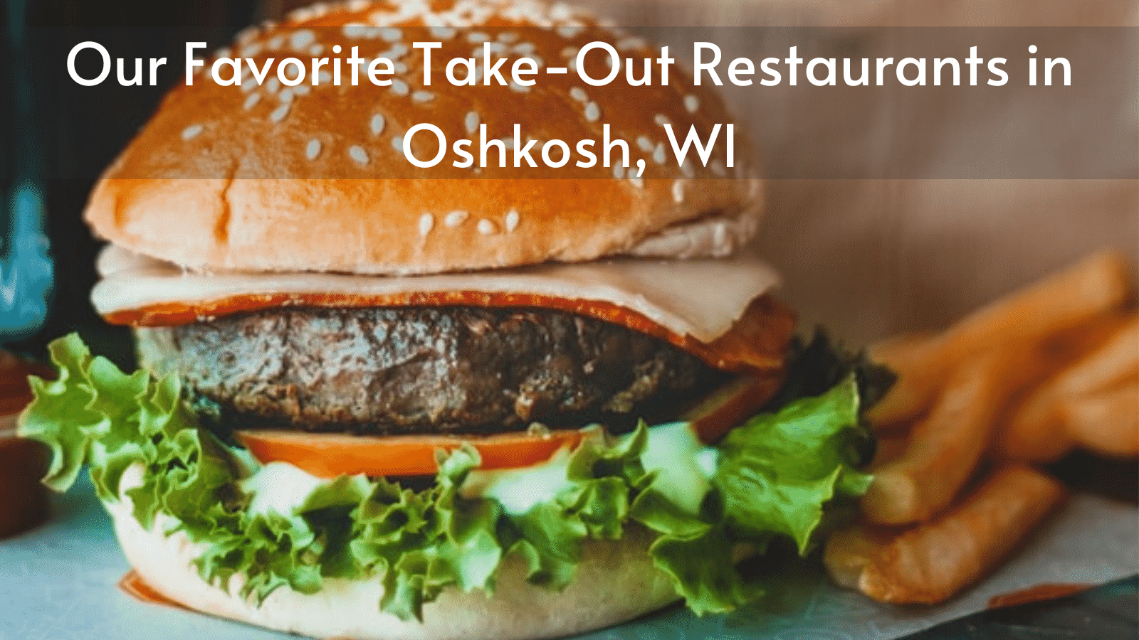 A hamburger and french fries are on a table in oshkosh wi