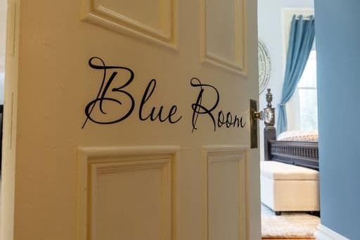 A white door with the word blue room written on it