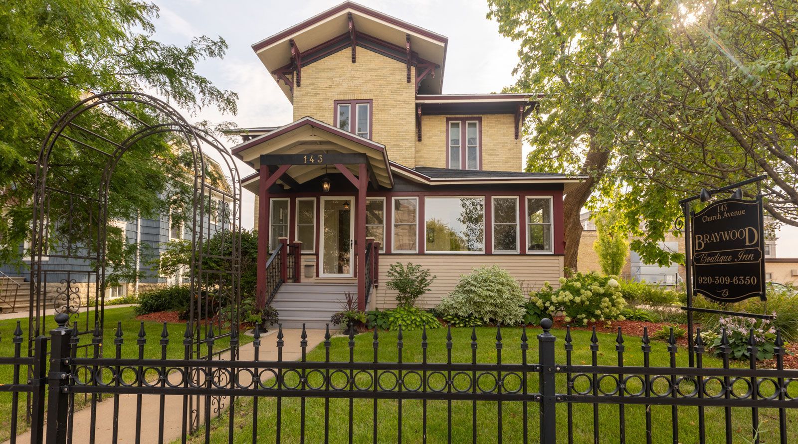 A large house with a wrought iron fence around it.