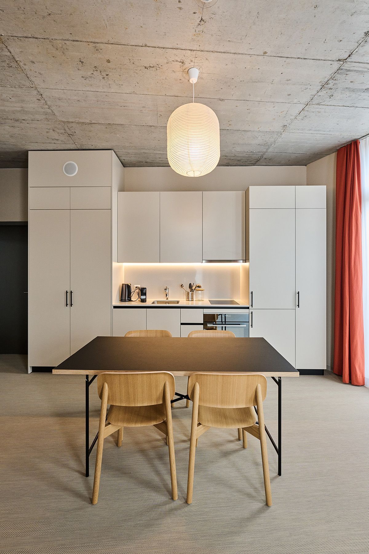 A kitchen with a table and chairs in it