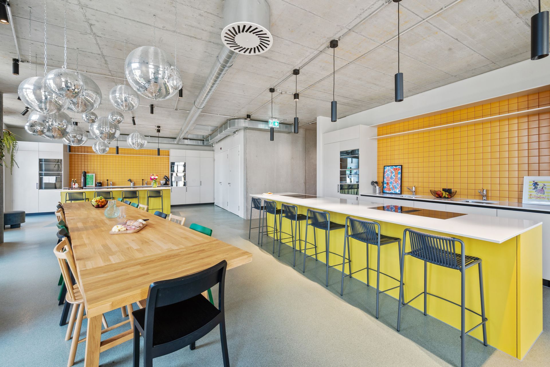 A kitchen with a long wooden table and chairs.
