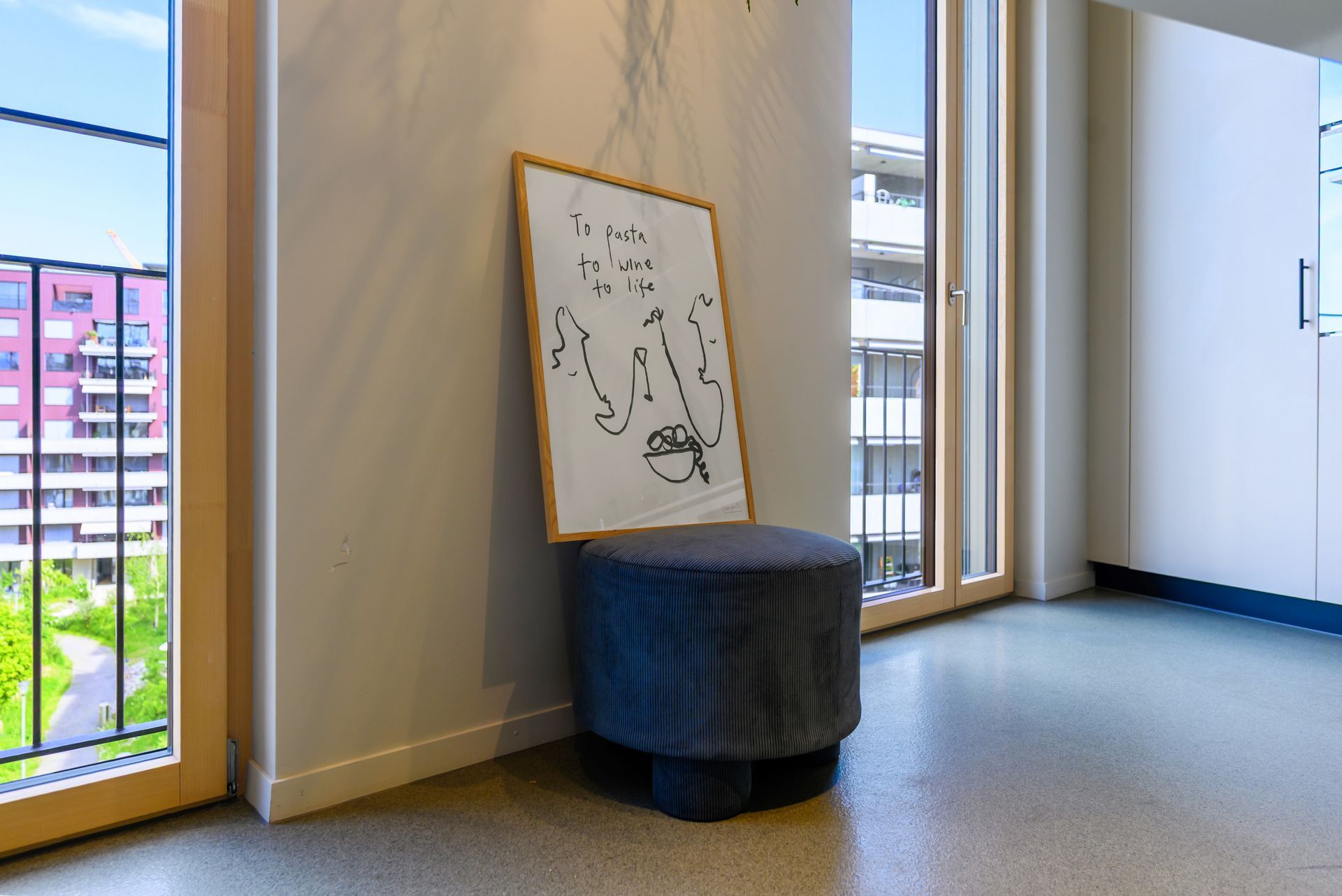 A room with a chair and a painting on the wall.