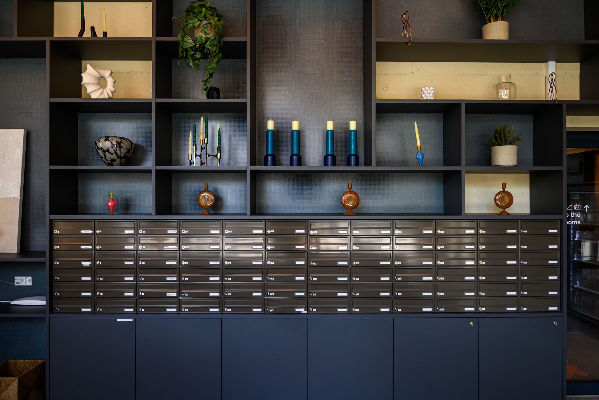 A room with a lot of shelves and boxes on the wall.