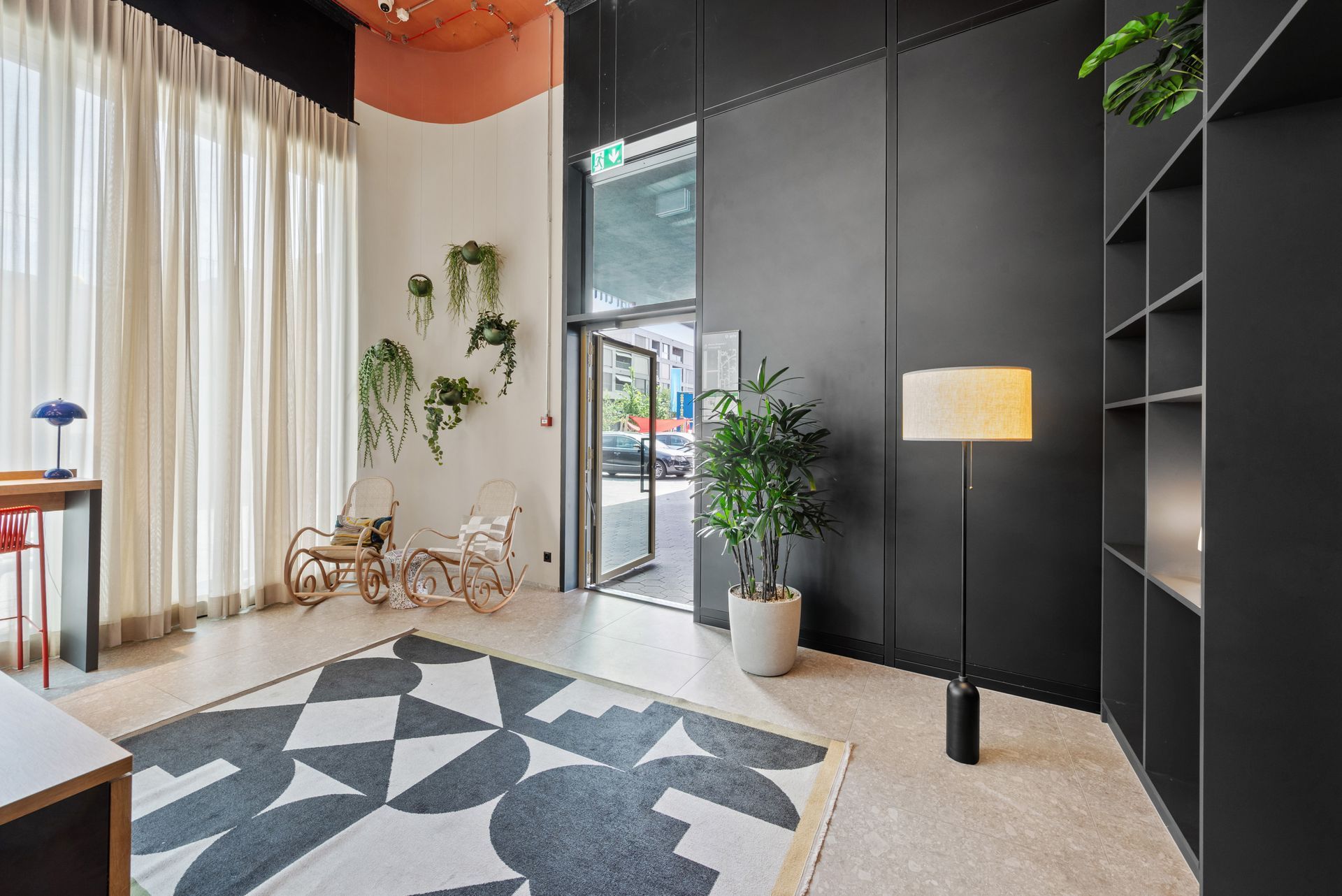 A living room with a rug and a lamp.