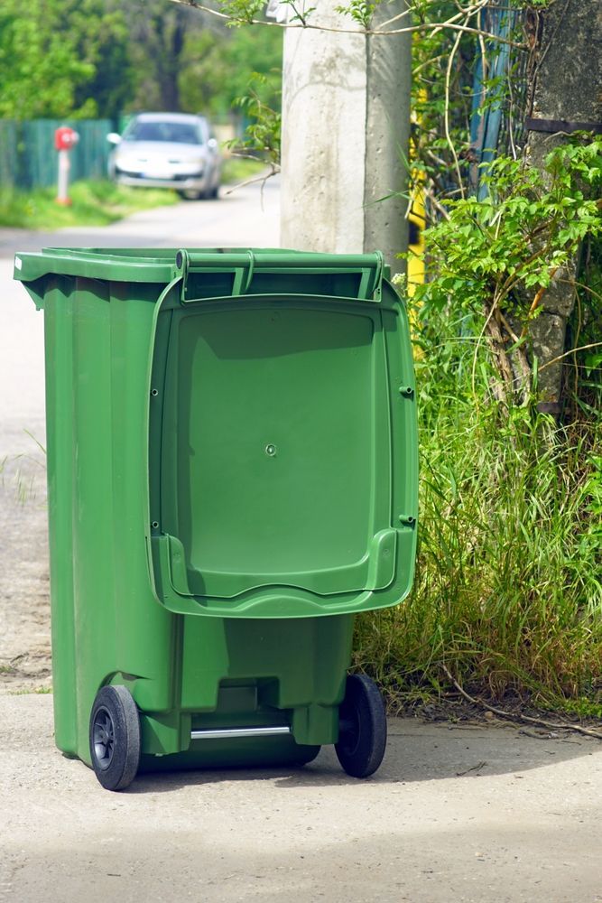 Green Trash Bin With Open Lid — All Suburbs Garden Bags in Palm Cove, QLD