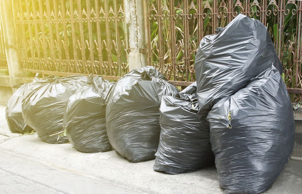 Black Trash Bags Lined Up — All Suburbs Garden Bags in Mount Sheridan, QLD