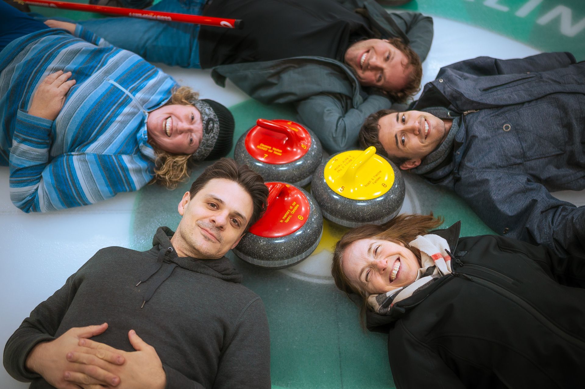 Rows of red seating in an auditorium with black walls and a yellow trim.