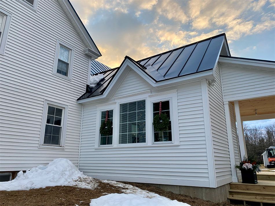 A house with a wooden porch and stairs in front of it.