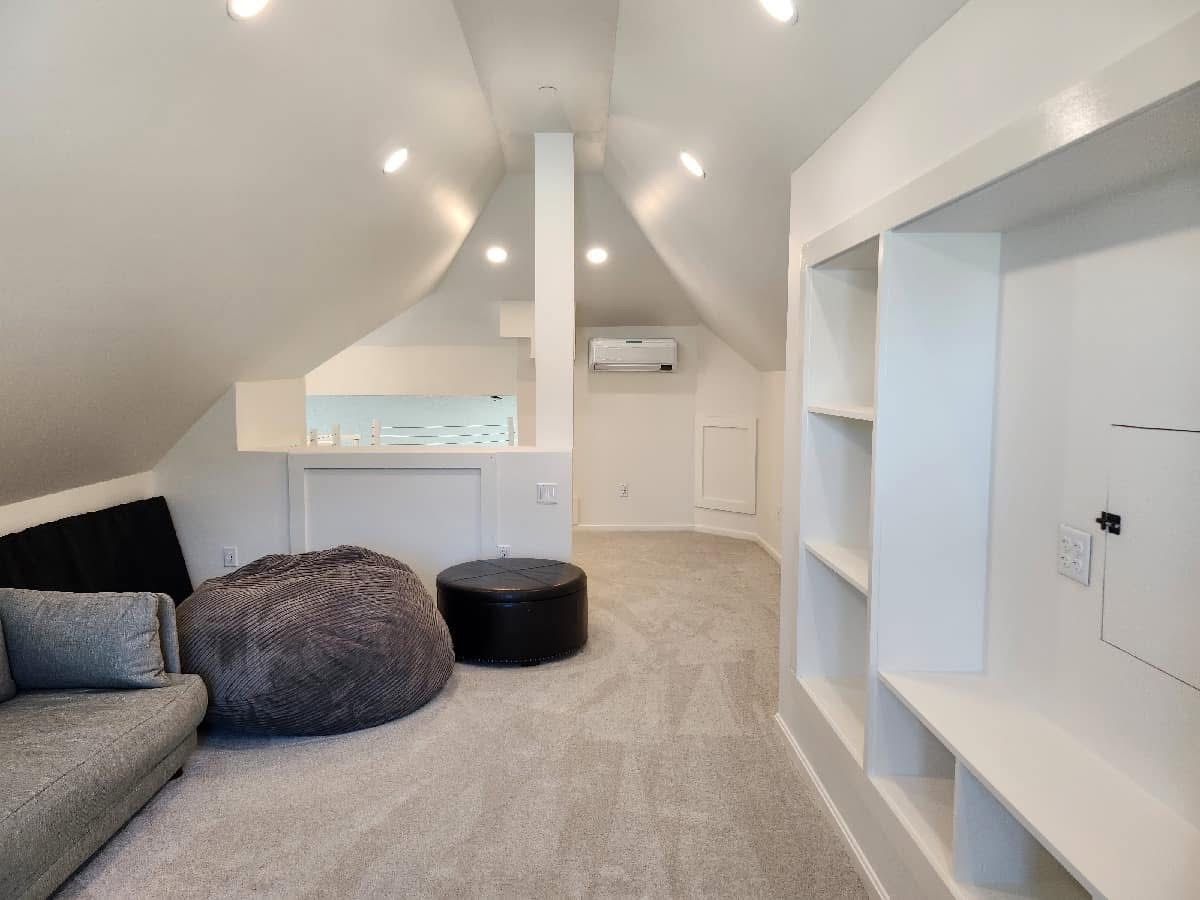 A living room with a couch , bean bag chair and ottoman.