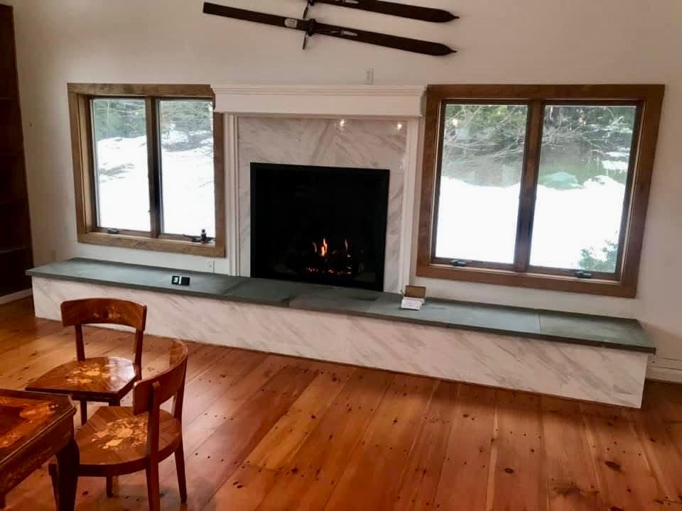 A living room with a fireplace and skis on the wall