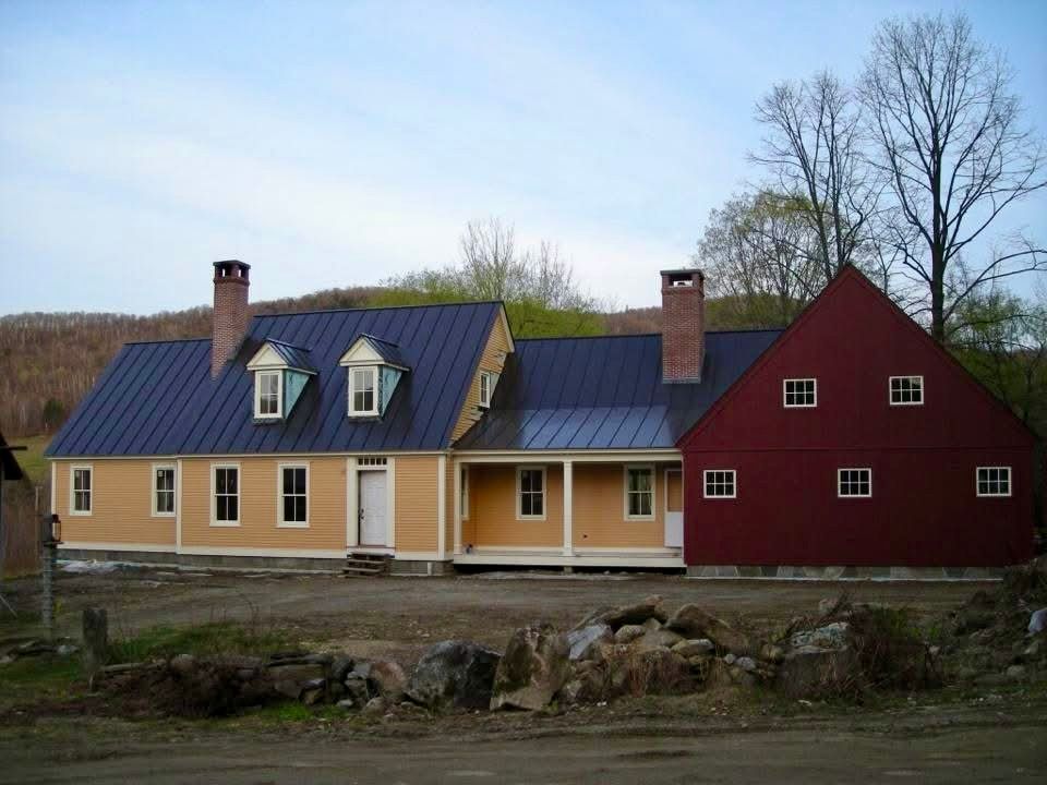 A yellow house and a red barn are next to each other