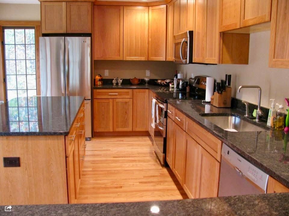 A kitchen with wooden cabinets and granite counter tops