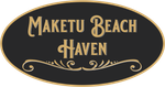 A black and gold sign that says maketu beach haven