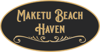 A black and gold sign that says maketu beach haven