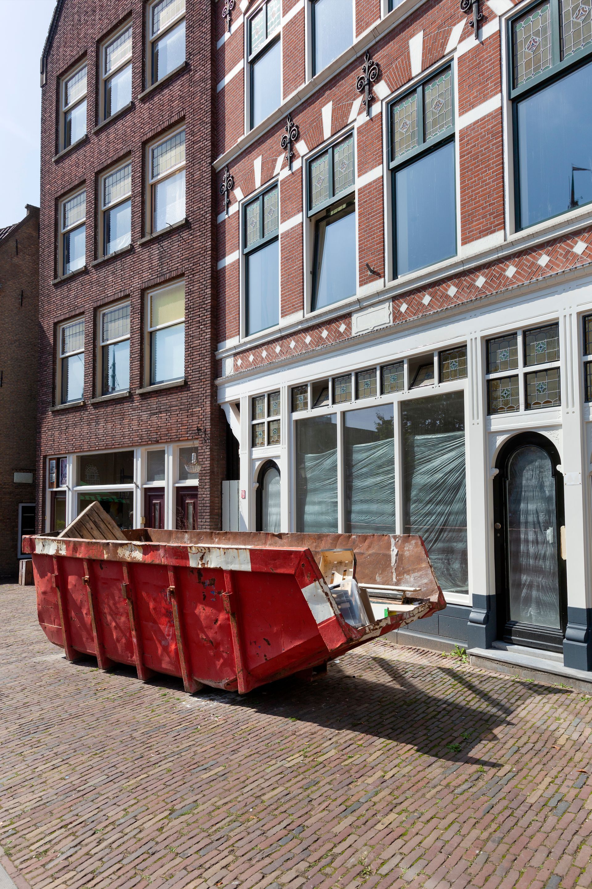 Red skip in a street in Rotterdam 