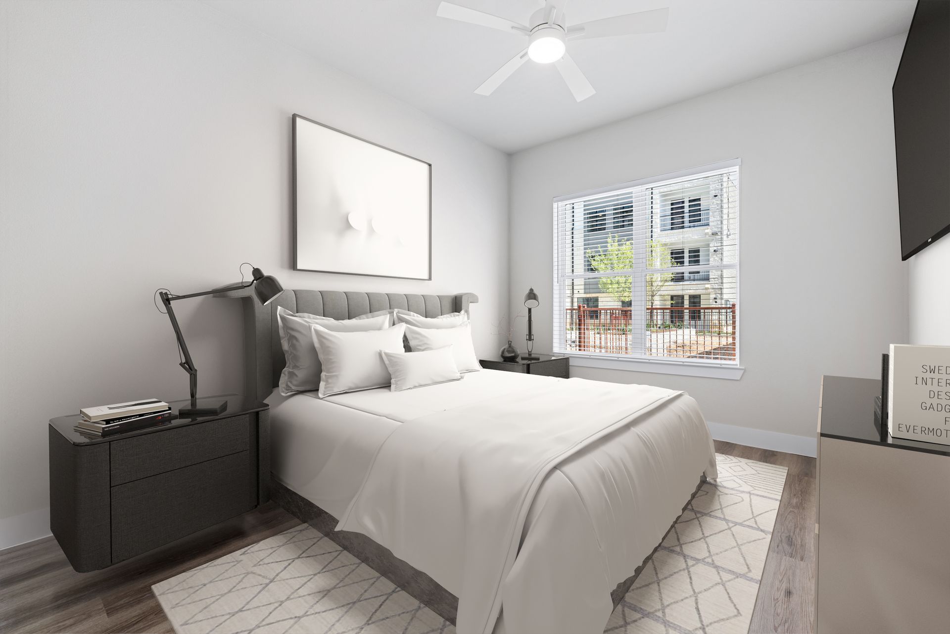 Spacious apartment bedroom with a bed, nightstand, and ceiling fan at The Wyatt, offers apartments in North Austin, TX.