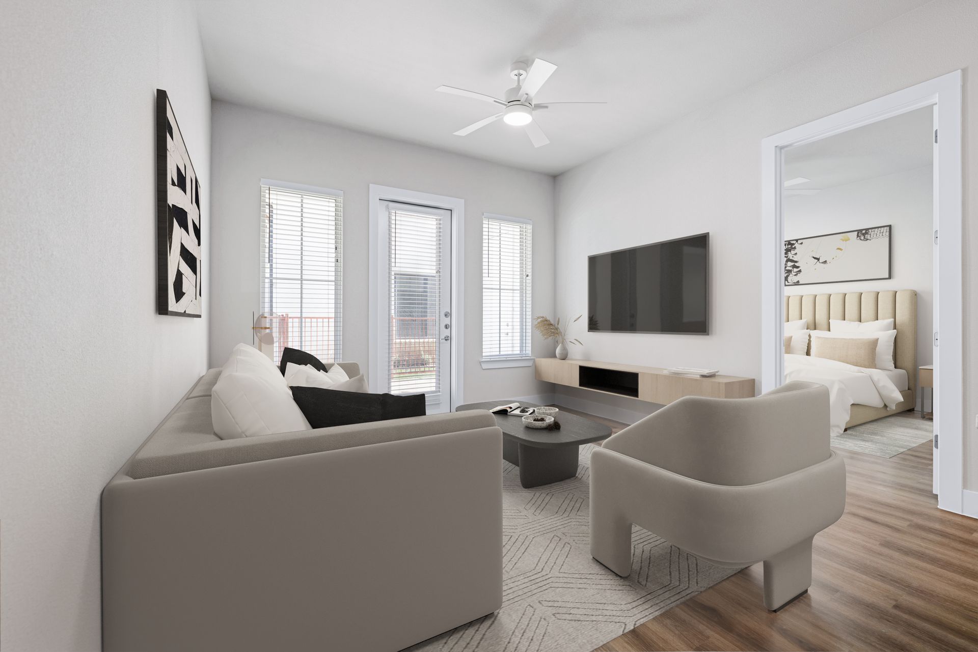 A living room with a couch, chair, coffee table, and television at The Wyatt, offers luxury apartments in North Austin, TX.