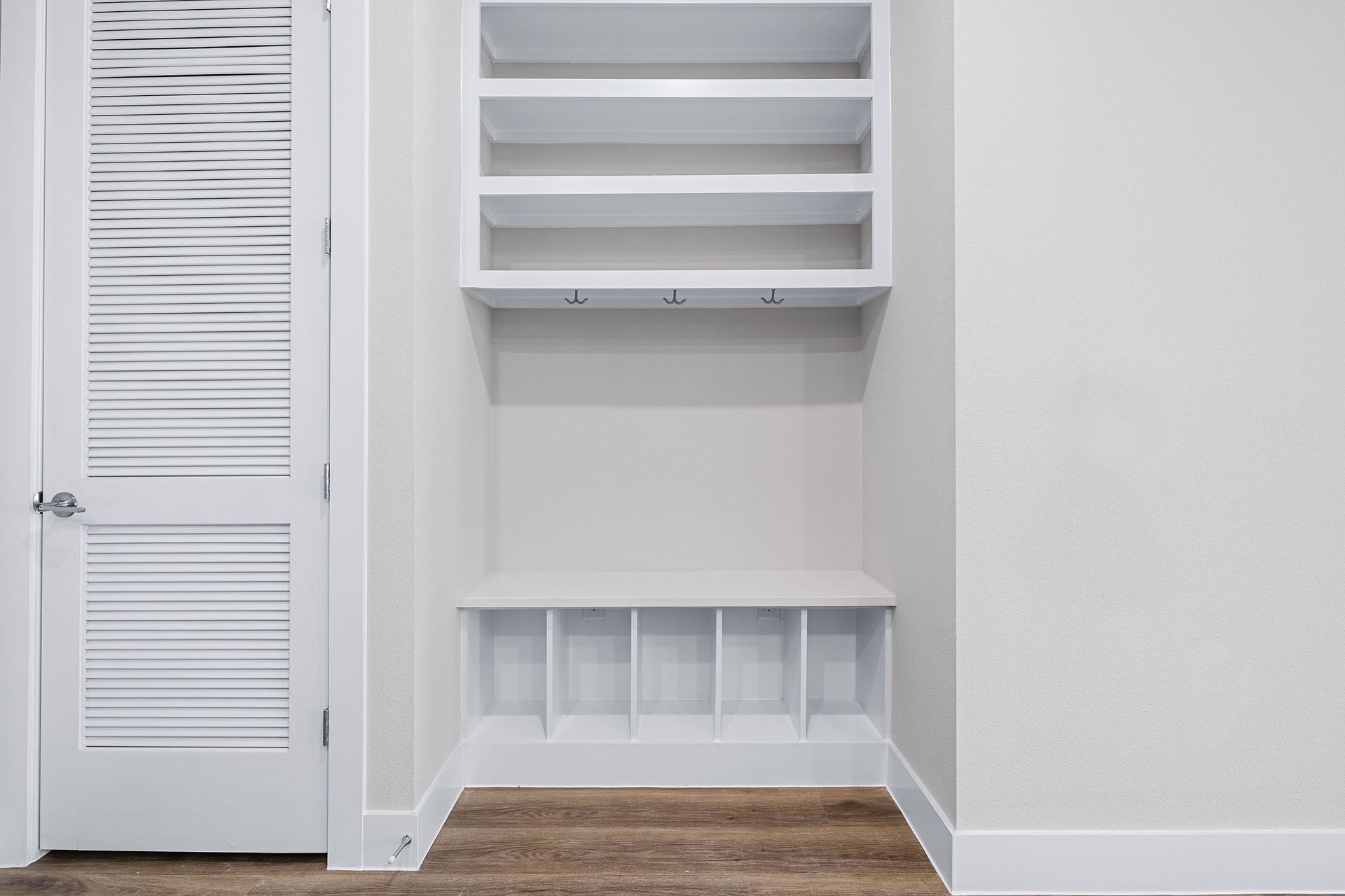 There is a closet with shelves and a door at The Wyatt, offers apartments in North Austin, TX.