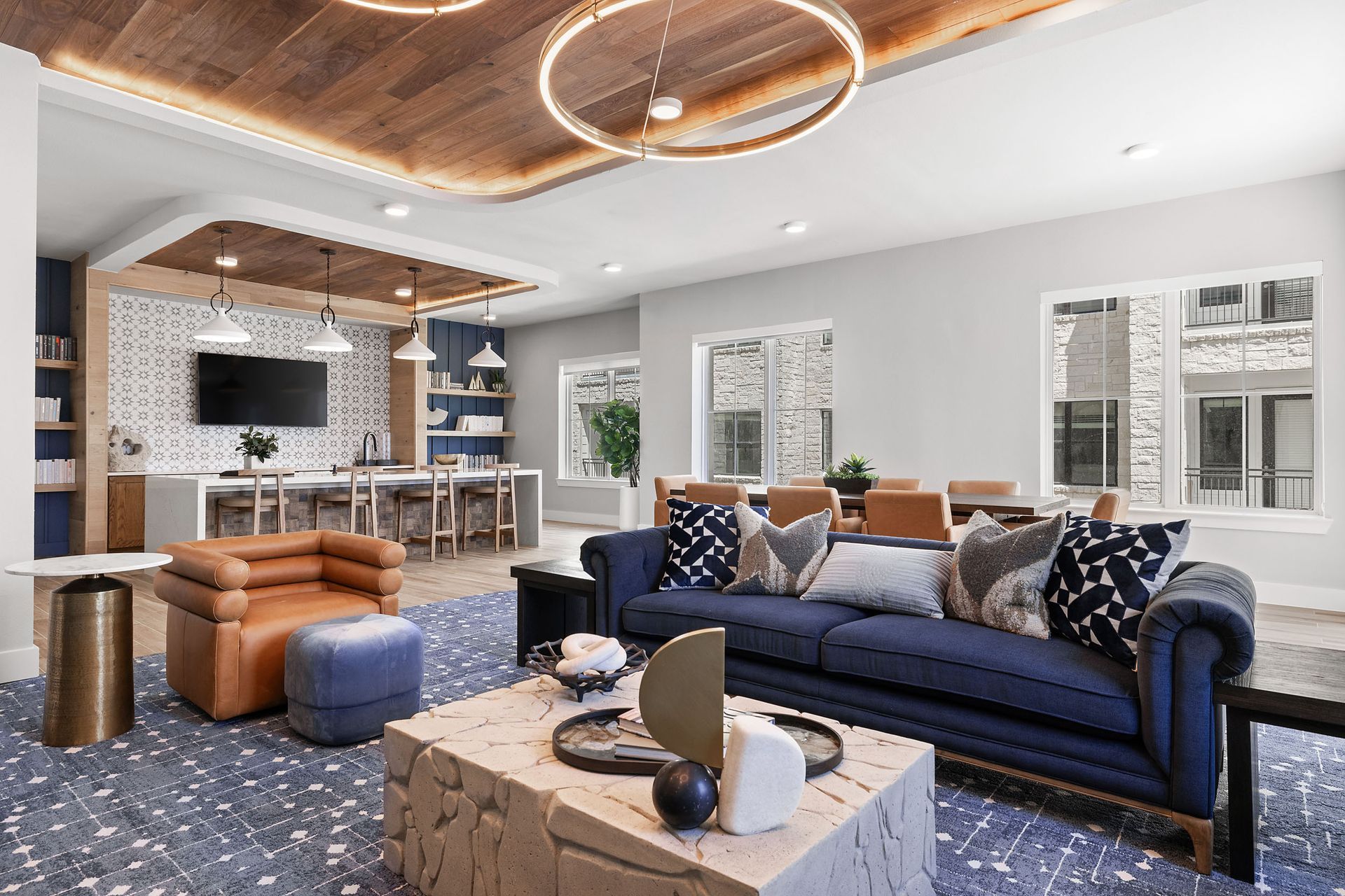 The clubhouse at The Wyatt with a blue couch and a brown chair.