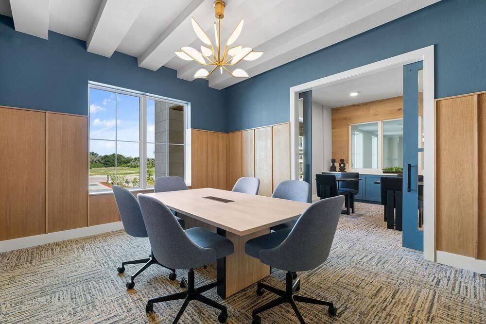 Austin apartments with co-working space and conference room with a table and chairs in it at The Wyatt, offers luxury apartments in North Austin, TX.