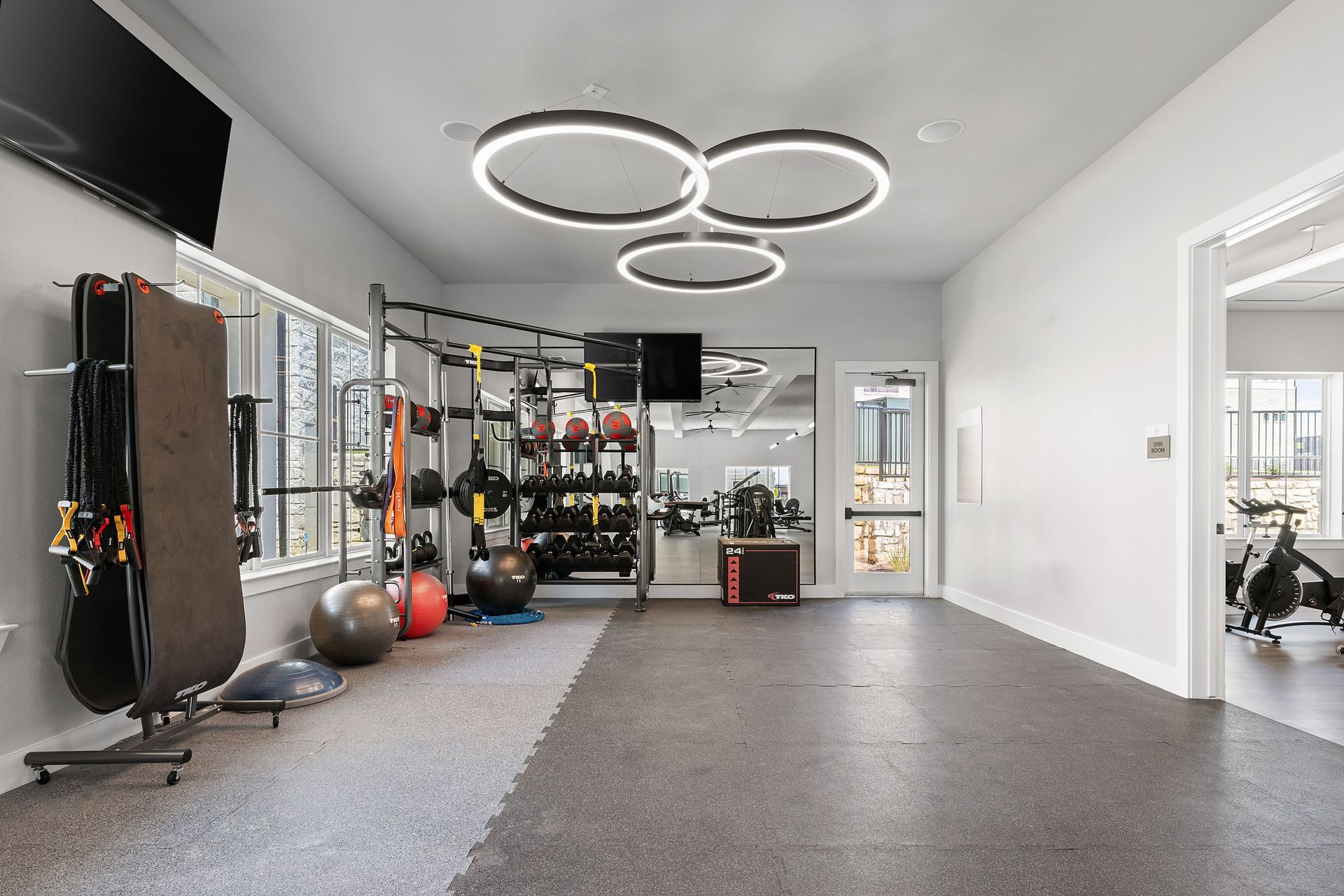 An artist's impression of a gym with a lot of exercise equipment at The Wyatt, offers luxury apartments in North Austin, TX.