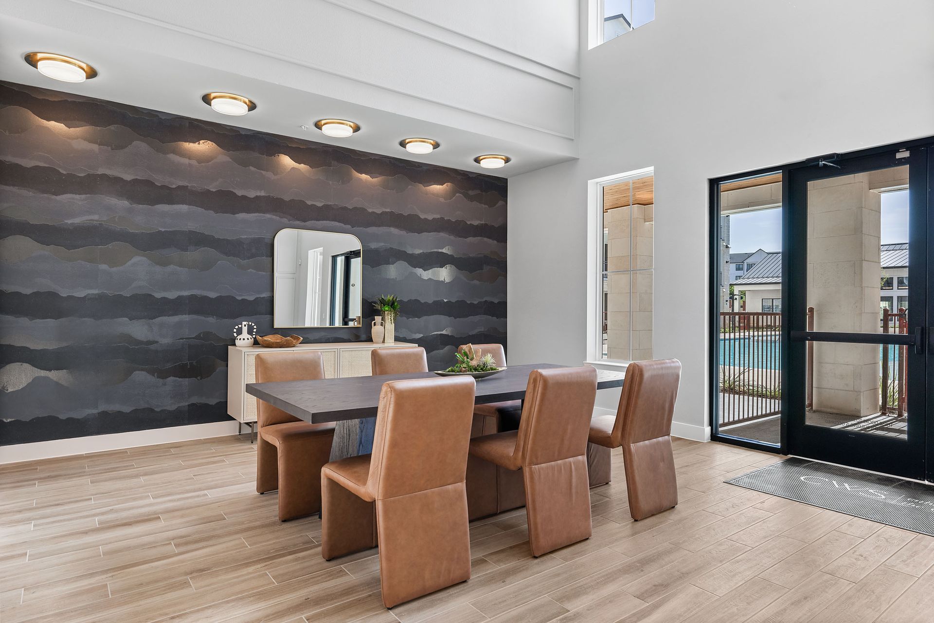Apartment community lobby with a table and chairs in it at The Wyatt, offers apartments for rent in North Austin, TX.