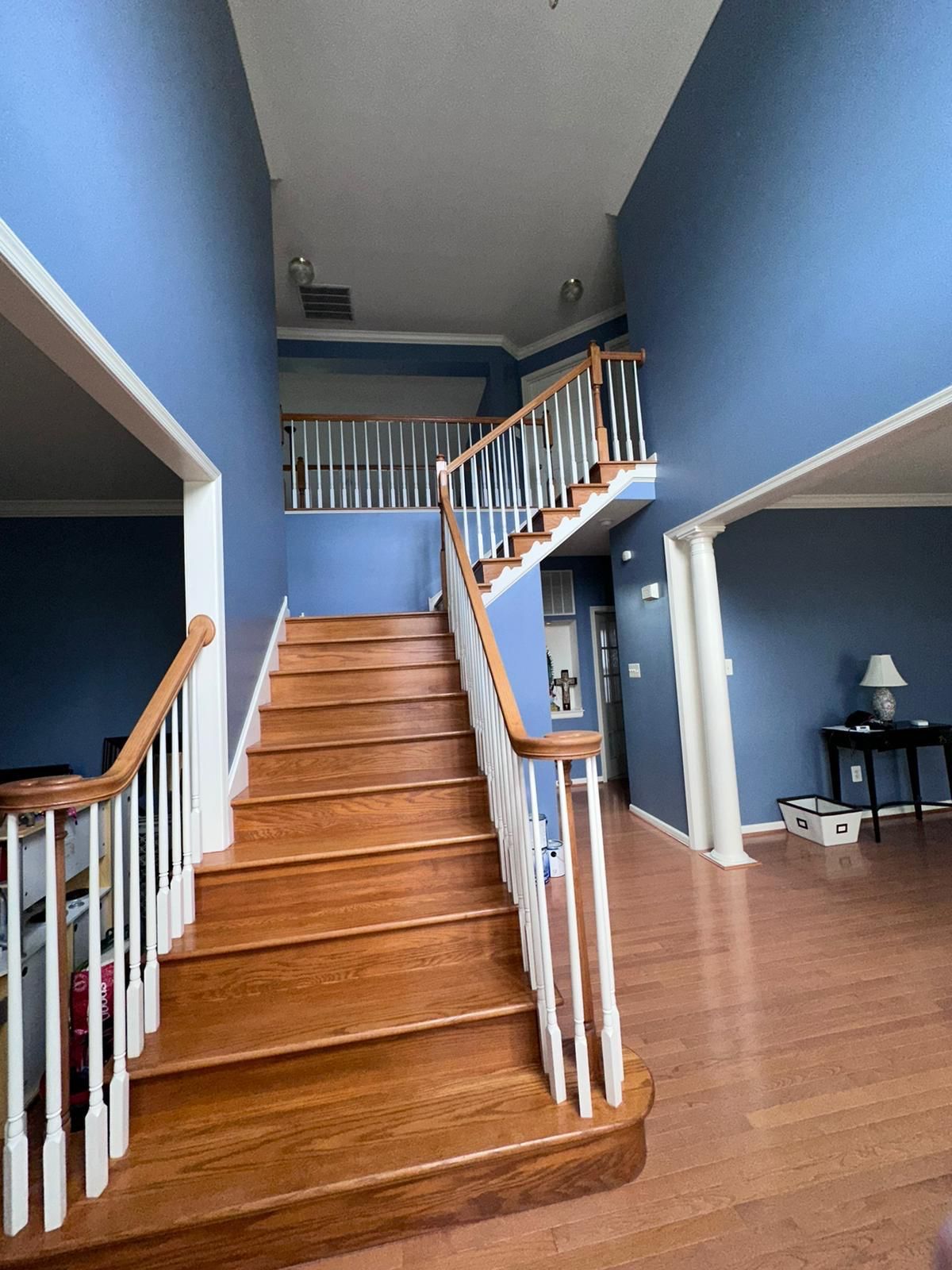 A wooden staircase in a house with blue walls