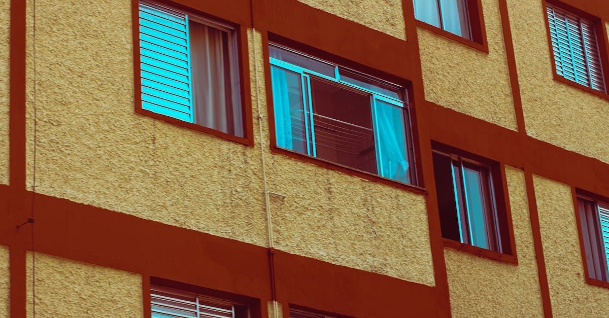 A building with a lot of windows and curtains on it.