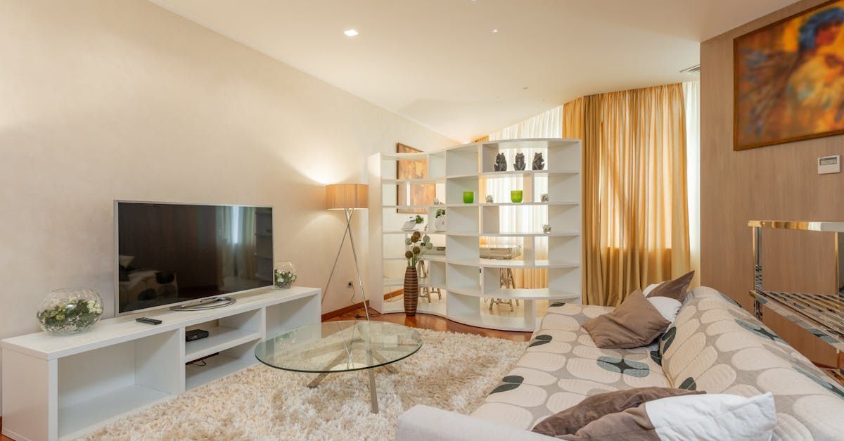 A living room with a couch , television , and coffee table.