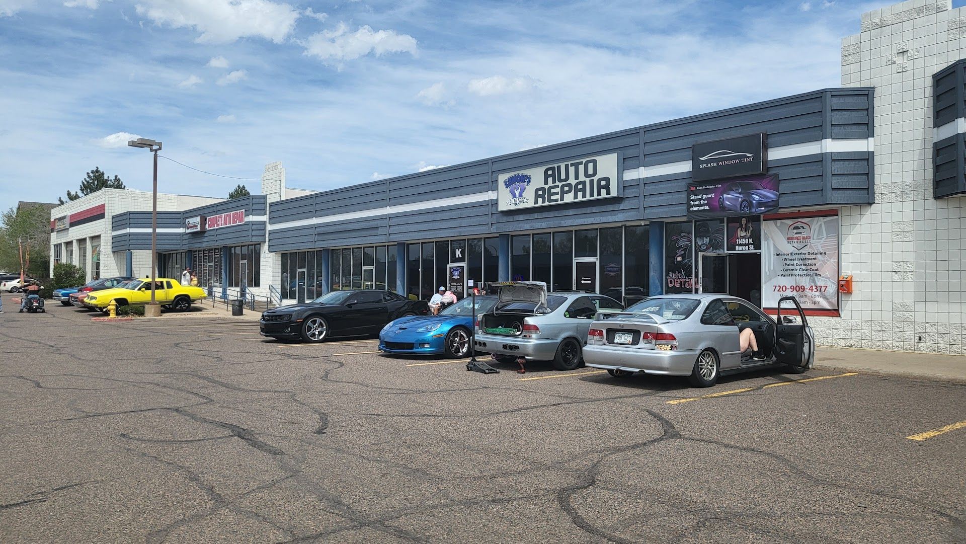 Auto repair shop with several cars parked outside on a sunny day. | Lenon's Tire & Auto Repair