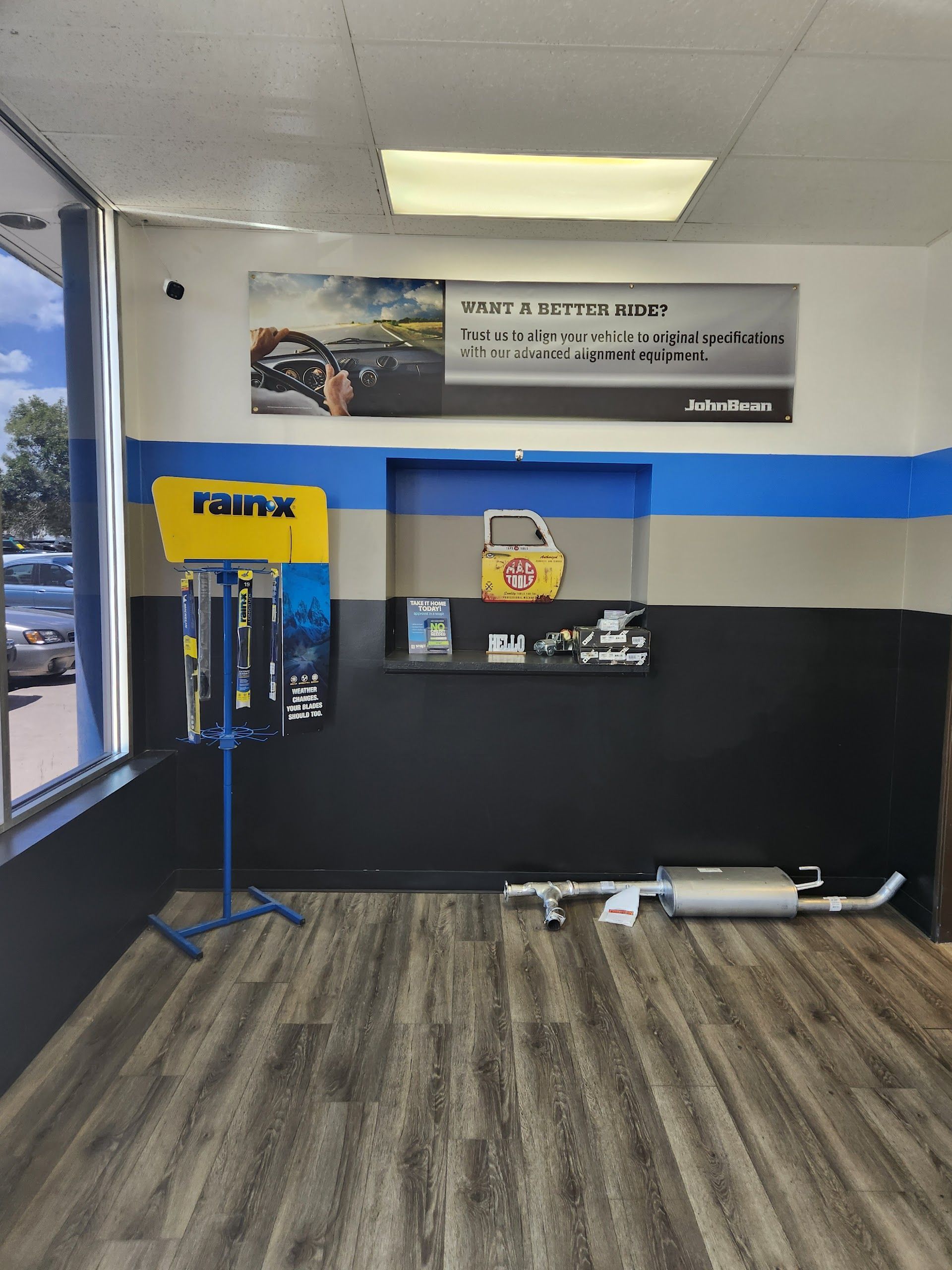 Interior of an auto parts store with a display rack and exhaust system on the floor. | Lenon's Tire & Auto Repair