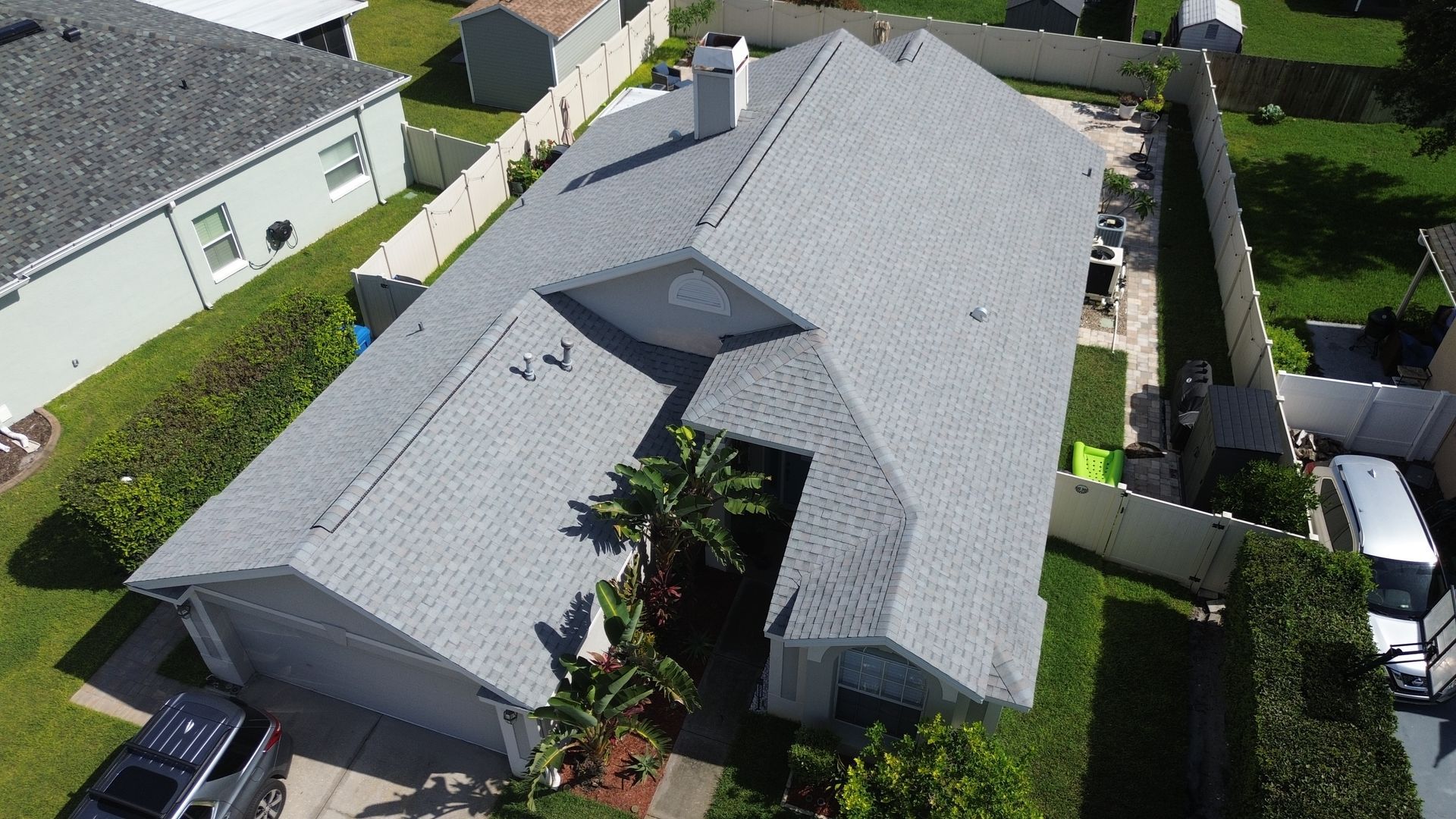 A white house with a black roof and a blue door