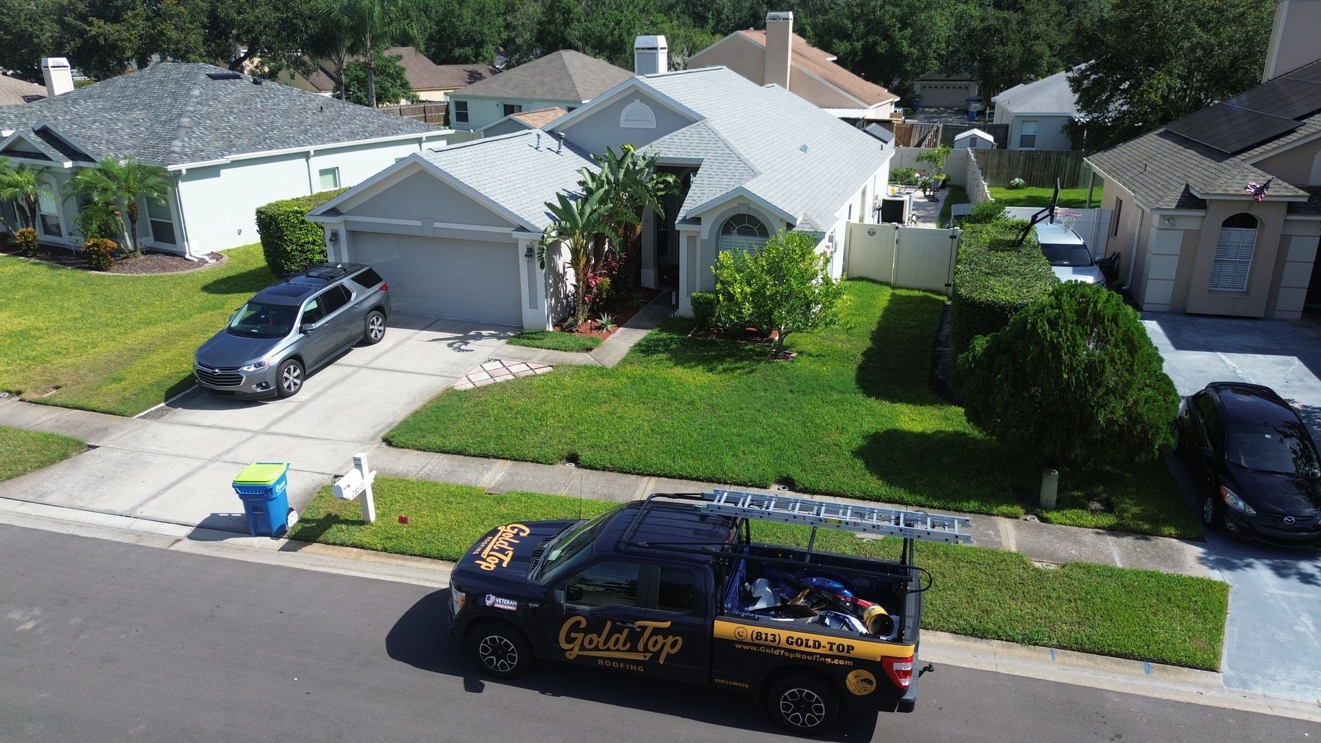 An aerial view of a house with a truck parked in front of it.