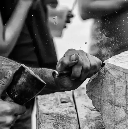 Hands Carving Stone With Chisel and Mallet; Sparks Fly — Verastone In Fyshwick, ACT