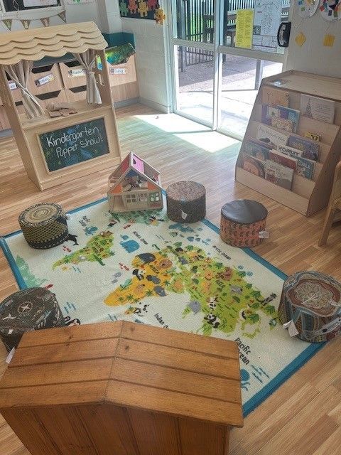 A Wooden Toy House On A Mat With Stools— Birralee Child Care Centre Assn Inc In Mackay, QLD