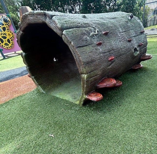 A Wooden Desk With an Open Book and a Pen on It — Birralee Child Care Centre Assn Inc In Mackay, QLD
