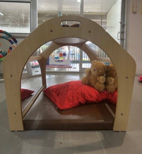 A Wooden Playhouse With A Teddy Bear— Birralee Child Care Centre Assn Inc In Mackay, QLD
