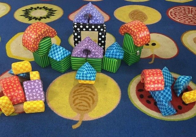 A Group of Children Are Sitting at Tables Painting With Watercolors — Birralee Child Care Centre Assn Inc In Mackay, QLD