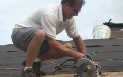 Keith Stern on a roof working on the roof.